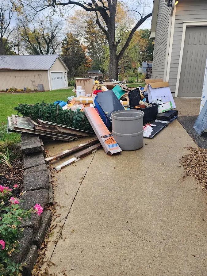 Dumpster being loaded with debris for Roofing Dumpster Rental in Orchards